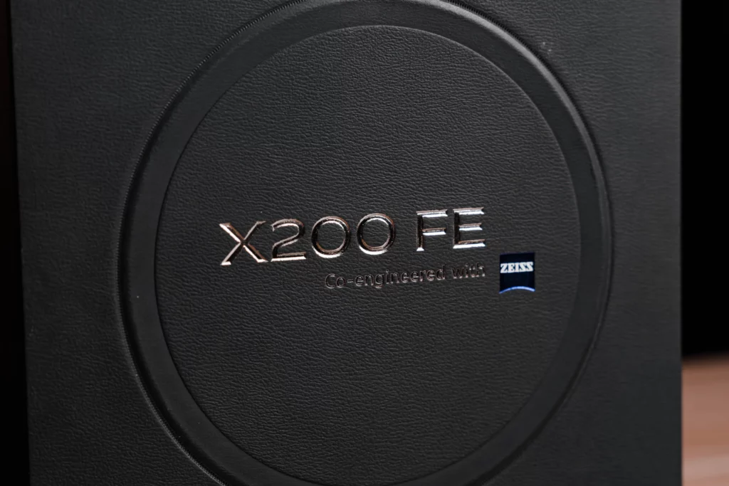 Close-up of a black box with "X200 FE Co-engineered with ZEISS" embossed.