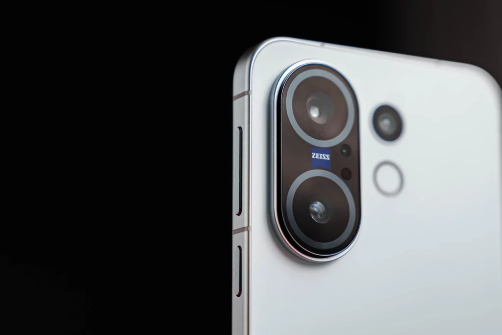 Close-up of the smartphone's camera module with ZEISS branding.