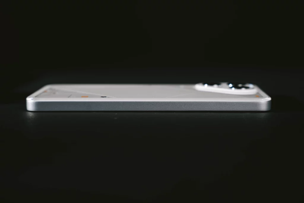 A side profile of the Tecno POVA 7 Ultra 5G, showing its thin body and the smooth transition from the white back panel to the metallic side frame.