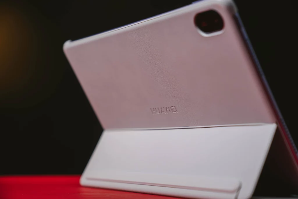 A side view of the HUAWEI MatePad 11.5 in a purple case, propped up by the smart keyboard cover. The image focuses on the case's texture and the tablet's back design.