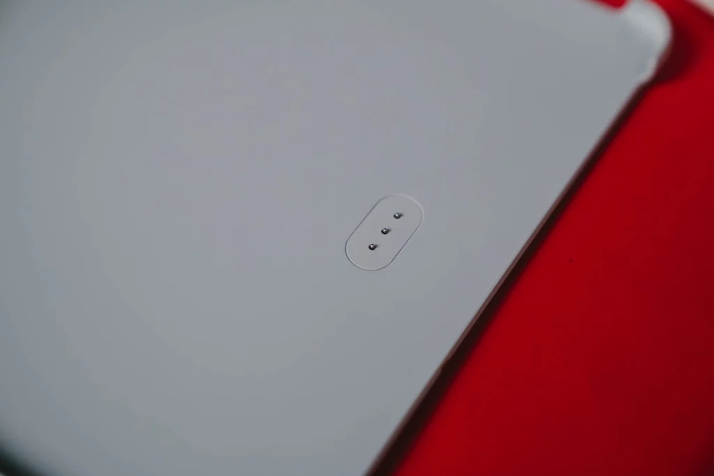 A close-up of the three magnetic connector pins on the back of the HUAWEI MatePad 11.5 tablet, used for attaching the smart keyboard.