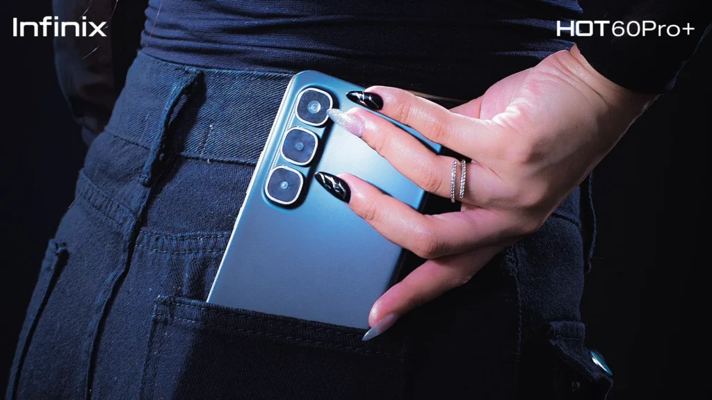 A close-up shot of the sleek, blue Infinix HOT 60 Pro+ being placed in a back jeans pocket, highlighting its thin design.
