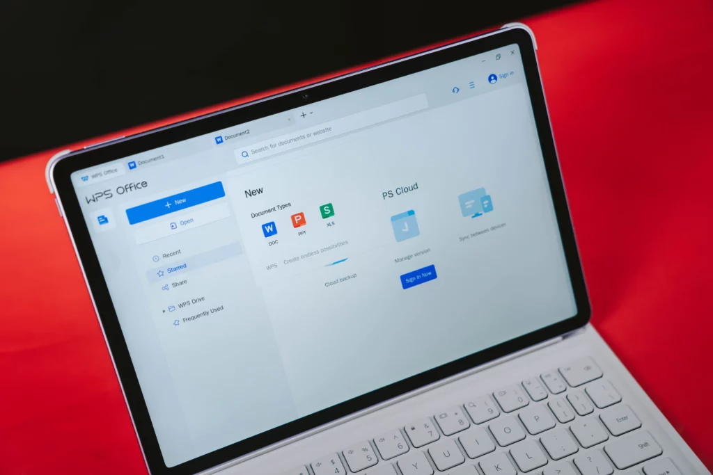 A person using the HUAWEI MatePad 11.5 tablet with the white smart keyboard to view the WPS Office suite, showing the interface for creating new documents, presentations, and spreadsheets.