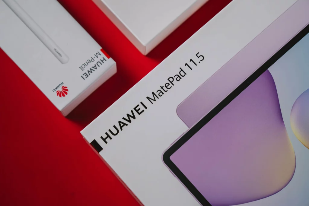 A high-angle view of the product boxes for the HUAWEI MatePad 11.5 and the HUAWEI M-Pencil, laid out on a vibrant red surface.