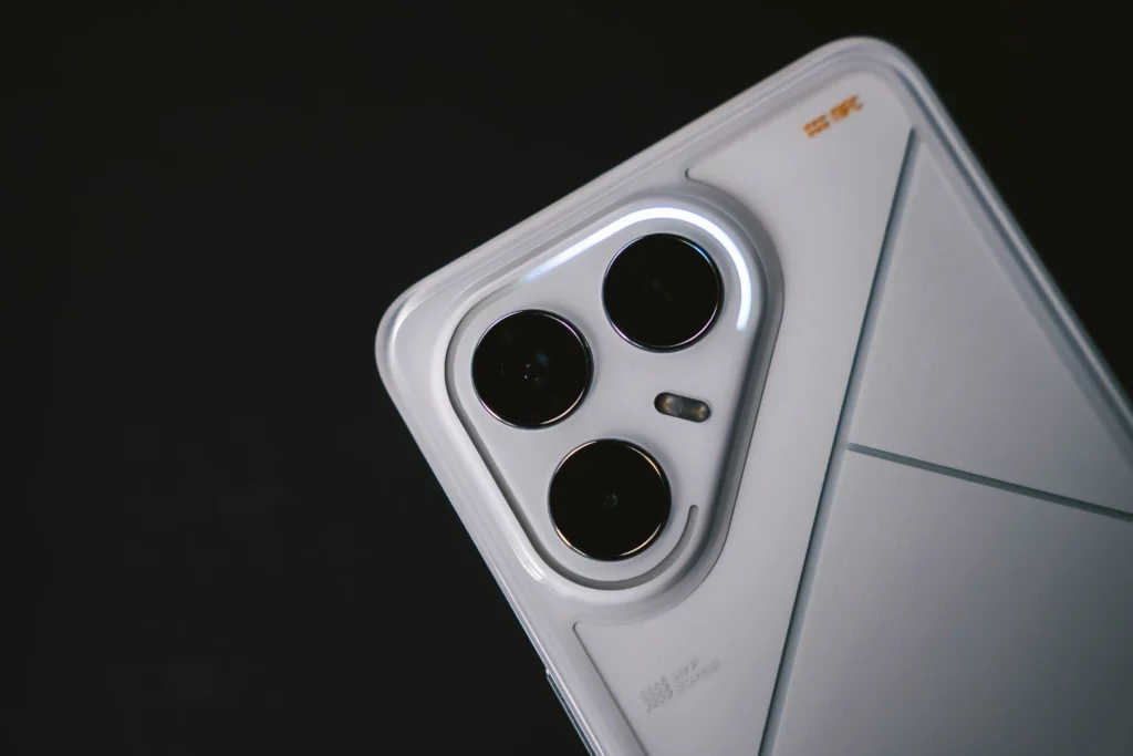 Close-up of the triple-camera system on the back of the TECNO POVA 6 Pro 5G, with the LED ring light illuminated around the lenses, emphasizing the camera's design.