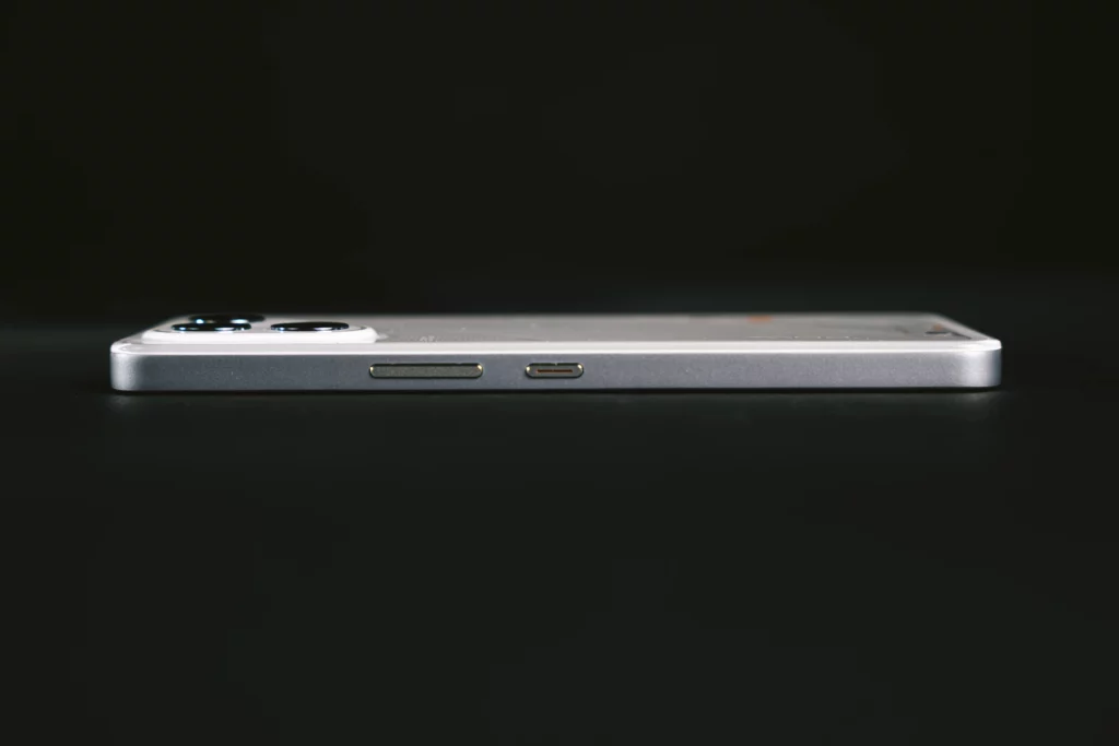 Side view of the TECNO POVA smartphone, showing the right edge with a power button, volume rocker, and a USB-C port.