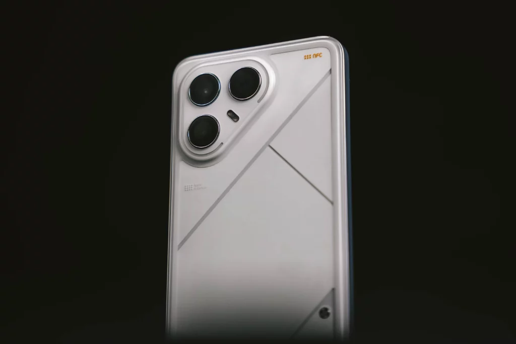 Close-up of the top portion of the TECNO POVA 6 Pro 5G's back, highlighting the triple-camera setup and the mecha-inspired design lines.