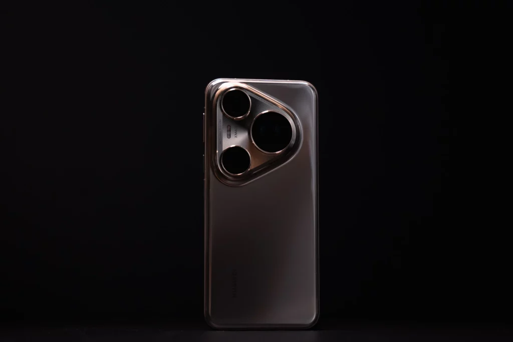 Back view of the HUAWEI Pura 80 Ultra standing against a black background, highlighting its unique symmetrical triple-camera module in a shimmering, dark metallic finish.