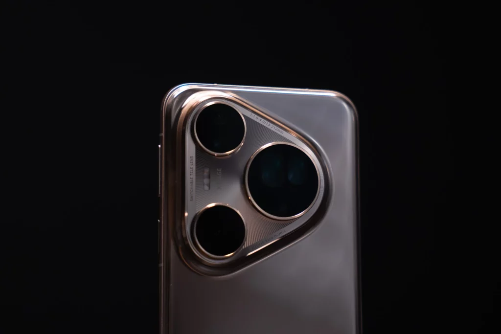 A close-up view of the distinct three-lens camera module of a silver HUAWEI Pura80 Ultra smartphone against a dark background. Details like "XMAGE" and lens specifications are visible.