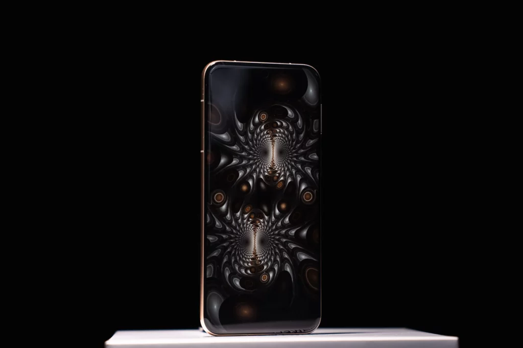 A HUAWEI Pura80 Ultra smartphone standing upright, displaying a dark, symmetrical fractal pattern on its screen with white and golden accents, against a black background.