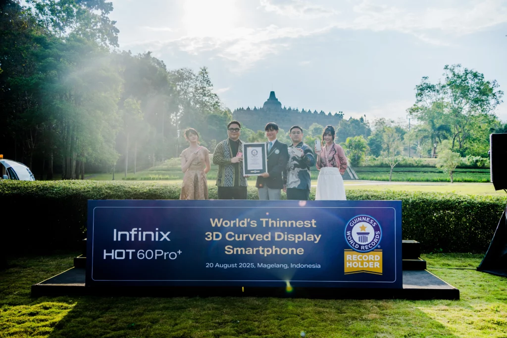 A group of people, including representatives from Infinix and Guinness World Records, stand behind a large sign announcing the Infinix HOT 60 Pro+ as the "World's Thinnest 3D Curved Display Smartphone" in an outdoor setting with a temple in the background.