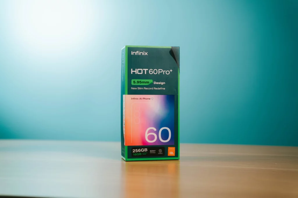 Front view of the Infinix HOT 60 Pro+ smartphone box, highlighting 5.95mm design and 256GB/16GB specs.