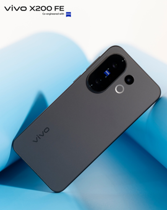 A product shot of the gray vivo X200 FE smartphone with its camera module clearly visible. The camera is co-engineered with ZEISS. The phone is placed against a blue and light-colored background.