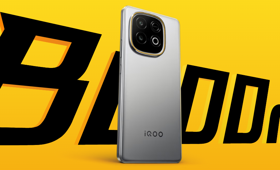 A silver iQOO smartphone is shown from the back against a bright yellow background with blurred black text. The phone features a prominent, glossy black camera module with four circular lenses and a gold accent around it. The iQOO logo is visible near the bottom of the phone.
