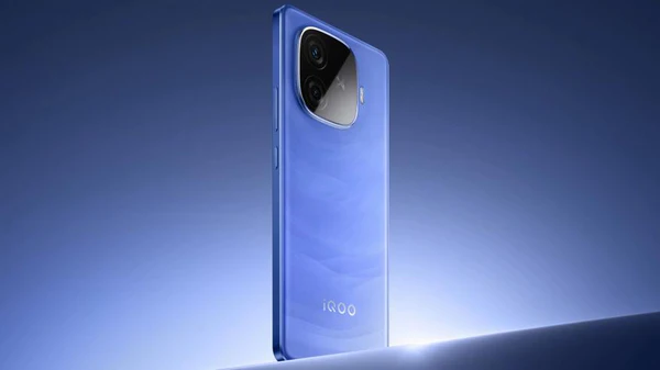 A blue iQOO Z10 Turbo Pro smartphone is shown from a back and side angle, highlighting its camera module and a wavy pattern on the rear panel against a blue background with a bright light source below it.