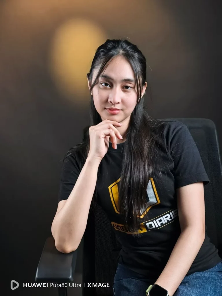 A young woman with long dark hair, wearing a black t-shirt, is seated and posing with her chin resting on her hand, looking confidently at the camera. The HUAWEI Pura80 Ultra | XMAGE watermark is in the bottom left corner.