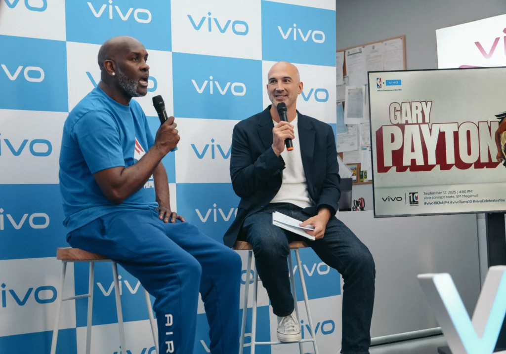 NBA Hall of Famer Gary Payton, wearing a blue shirt, sits on stage with host KC Montero, holding microphones during a Q&A session at the vivo Philippines 10th anniversary event in Manila.