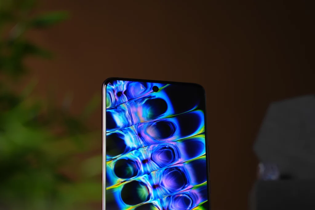 A close-up shot of the Vivo V60's screen, highlighting the punch-hole camera and a vibrant, swirling wallpaper with blue, purple, and green patterns.