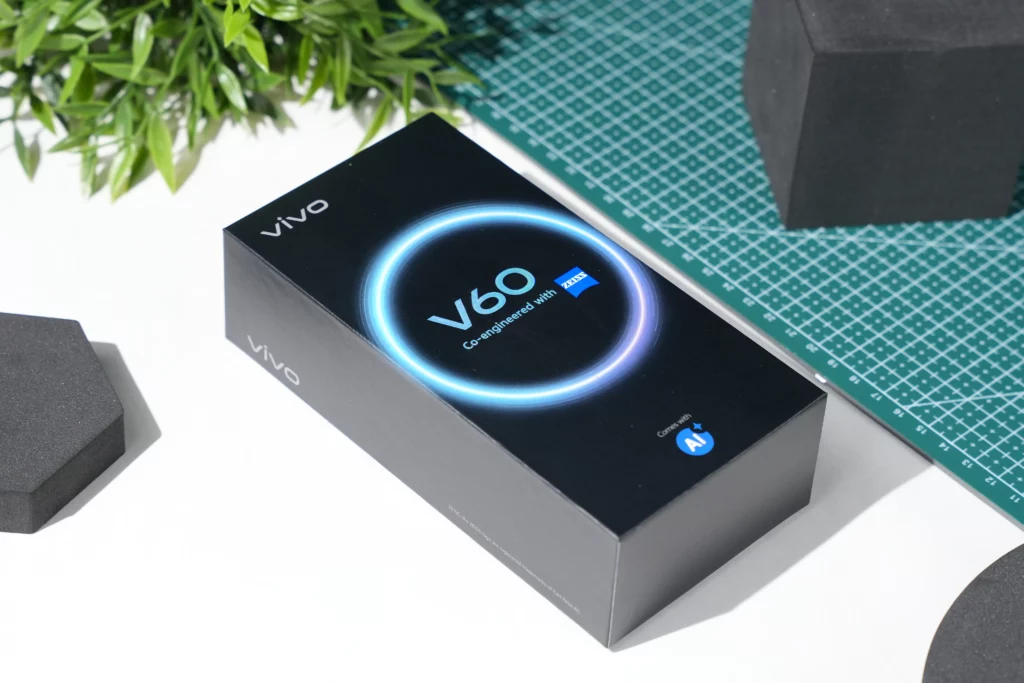 A close-up, high-angle shot of the Vivo V60 box, highlighting the "V60 Co-engineered with ZEISS" branding and the "Comes with AI" logo.
