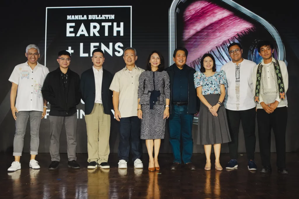 A group of people, including key representatives and content producers, standing side-by-side on a stage in front of the Manila Bulletin Earth+Lens backdrop.