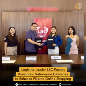 A photo of the LBC and Kimstore partnership signing ceremony. Four individuals are standing behind a table, with two shaking hands in the middle while holding signed documents. A red LBC banner is in the background. A yellow banner at the bottom reads "Logistics Leader LBC Powers Kimstore's Nationwide Deliveries to Enhance Filipino Online Shopping."
