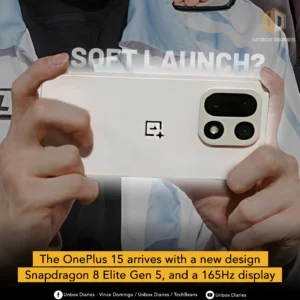 An advertisement for the new OnePlus 15 smartphone. The image is a close-up shot of a person's hands holding a white or pale gold-colored phone from the back, with the camera module prominently featured. The camera module is a large, circular design with a flash and two large lenses. The OnePlus logo is in the center of the phone's back. The words "SOFT LAUNCH?" are in bold, white text at the top. A yellow banner at the bottom reads, "The OnePlus 15 arrives with a new design Snapdragon 8 Elite Gen 5, and a 165Hz display."