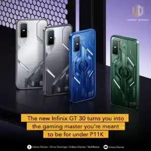 A promotional image displaying four color variants of the Infinix GT 30 gaming smartphone, each featuring a unique geometric, mecha-style design on the back. The phones are standing upright on a dark, reflective surface against a purple background with a honeycomb mesh. From left to right, the colors appear to be white/silver, gray, metallic blue, and forest green. A yellow text box at the bottom reads: "The new Infinix GT 30 turns you into the gaming master you're meant to be for under P11K," and the image includes "Unbox Diaries" branding.