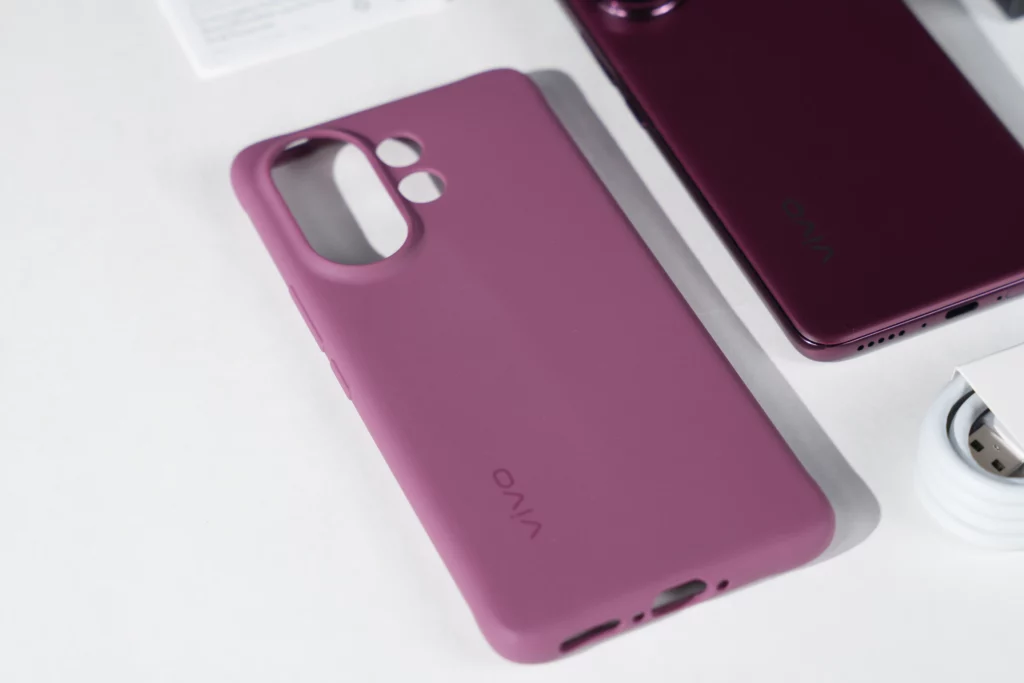 A close-up, high-angle shot of the Vivo V60's included purple protective case, with the VIVO logo embossed on the back, next to a part of the phone.