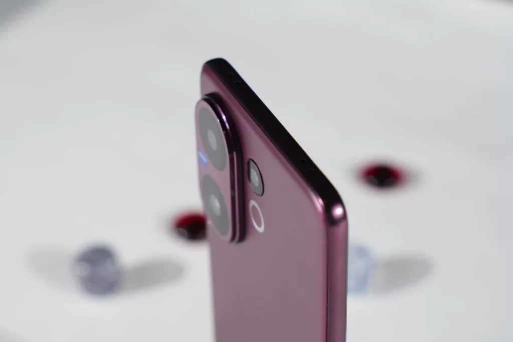 A close-up side-profile shot of the Vivo V60, focusing on the phone's sleek frame, the raised camera module, and the power and volume buttons, with a blurred background.