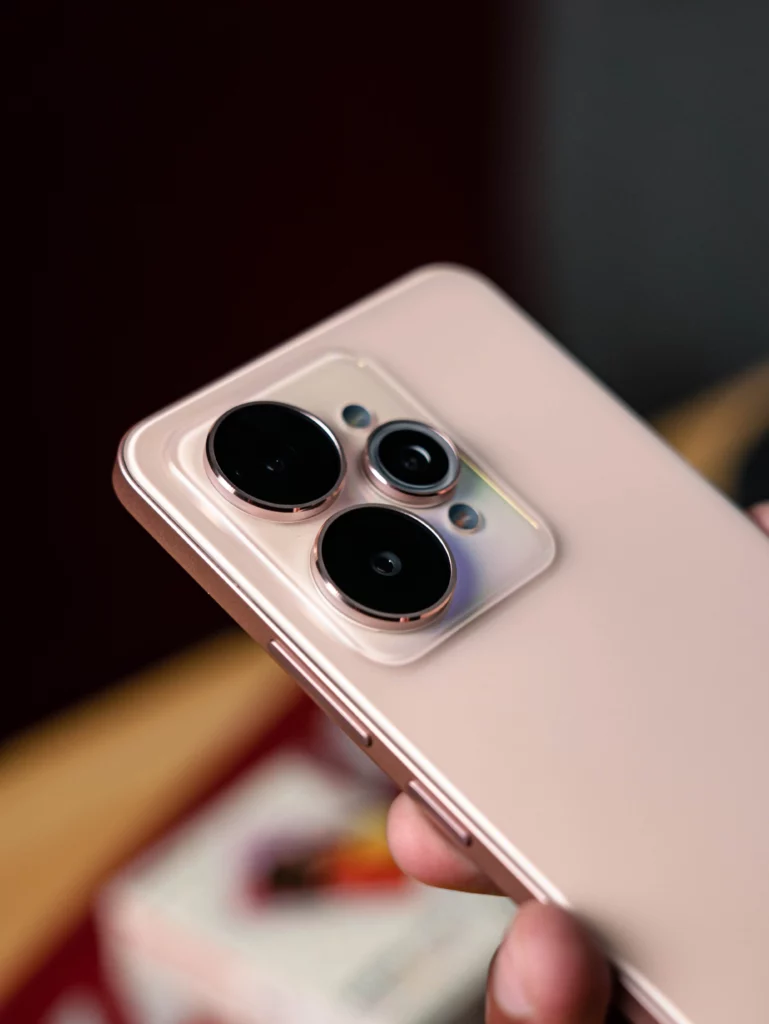 A close-up shot of the realme 15 5G's camera module, highlighting the three distinct camera lenses and the circular flash unit on the champagne-gold back panel.