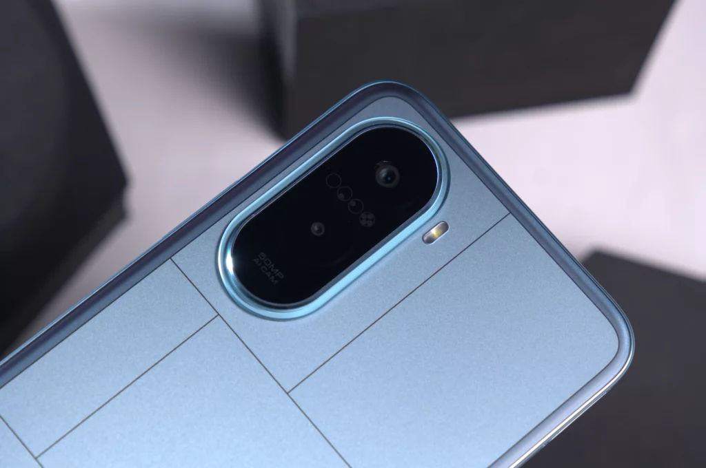 Close-up of the camera module on the back of a light blue POCO smartphone, showing the 50MP AI camera and flash.