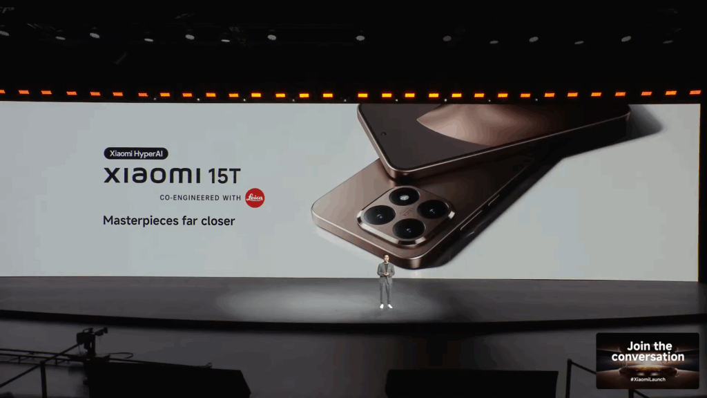 A large screen at the launch event displaying the "Xiaomi 15T" series, co-engineered with Leica, under the slogan "Masterpieces far closer." The screen also mentions "Xiaomi HyperAI," and features an image of two phones from the series.