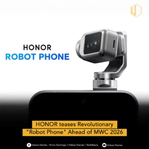An image of the HONOR ROBOT PHONE, showing a close-up of a small, metallic camera module attached to a silver robotic arm, emerging from the top of a dark phone body. The text teases a 'Revolutionary Robot Phone Ahead of MWC 2026'.