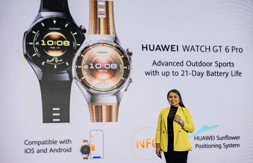 A woman in a yellow blazer stands on stage presenting the HUAWEI WATCH GT 6 Pro, with a large screen behind her displaying the smartwatch and key features, including "Advanced Outdoor Sports" and "up to 21-Day Battery Life."