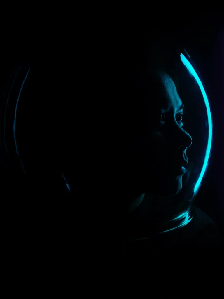 A man holding a candle inside a dimly lit cave or grotto, with the small flame casting a warm, dramatic light against the dark environment. (Photo by Rhon Velarde on HUAWEI P40 Pro)