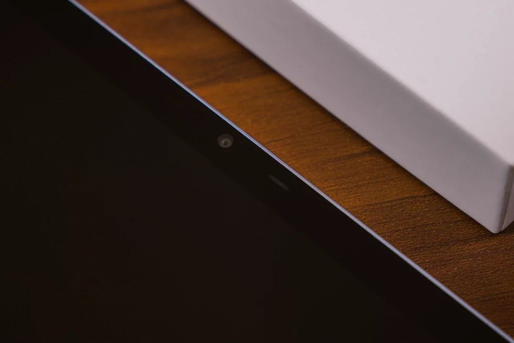 An extreme close-up of the top bezel of the tablet, clearly showing the front-facing camera lens and what appears to be a light sensor/indicator.