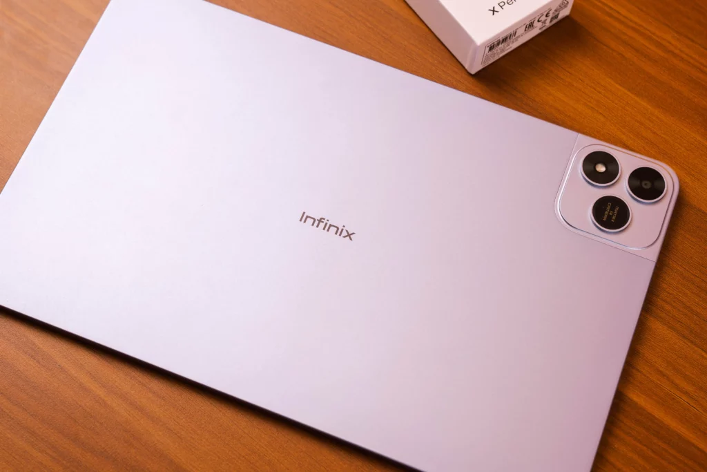A view of the back of the lavender/light purple Infinix XPAD 20 Pro tablet, showing the "Infinix" logo and the dual rear camera module in the corner.