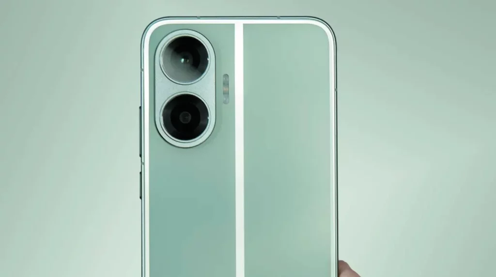 Close-up of the upper rear panel of a smartphone, possibly a Redmi Turbo 4 Pro, featuring a mint green or pale teal color with two prominent vertical white stripes. It has a dual-camera setup with large, circular lenses stacked vertically inside a metal module, and a flash unit next to it.