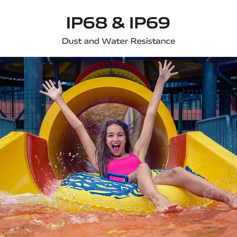 Close-up shot of a smiling girl excitedly riding an inner tube down a yellow water slide, with water splashing around her. Text overlay reads: "IP68 & IP69 Dust and Water Resistance."
