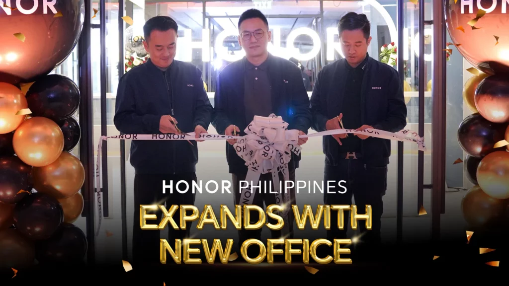 A high-resolution image focusing on the ribbon-cutting ceremony. Three men are standing side-by-side, each holding scissors to cut a white ribbon during the grand opening of the new HONOR office. Gold and brown balloons frame the scene. The text overlay reads: "HONOR PHILIPPINES EXPANDS WITH NEW OFFICE".