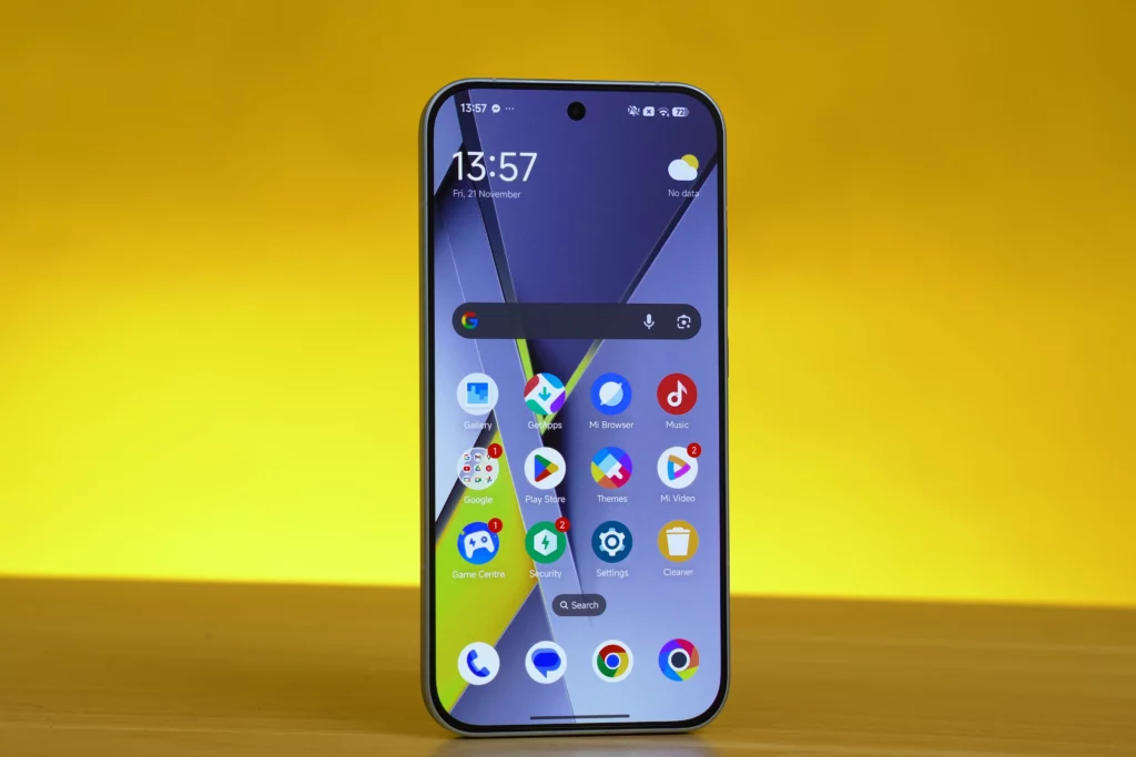 The POCO F8 Pro's screen shows the home screen interface with various app icons, the Google search bar, and the time displayed as 13:57.