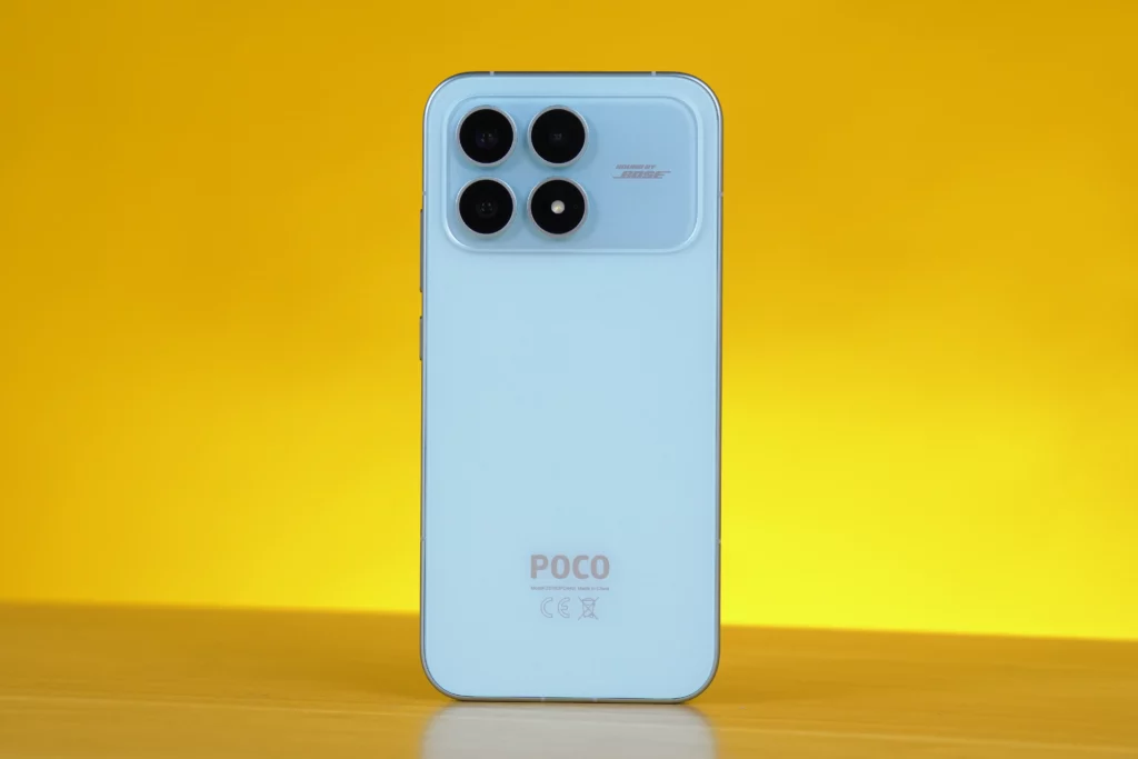 Back view of the light blue POCO F8 Pro smartphone, highlighting the silver-accented square camera module with four separate lenses and the 'SOUND BY BOSE' branding.