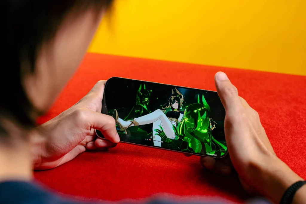 A person holding the POCO F8 Ultra horizontally, playing a mobile game with a female character in an outfit with green and gold accents displayed prominently on the screen.
