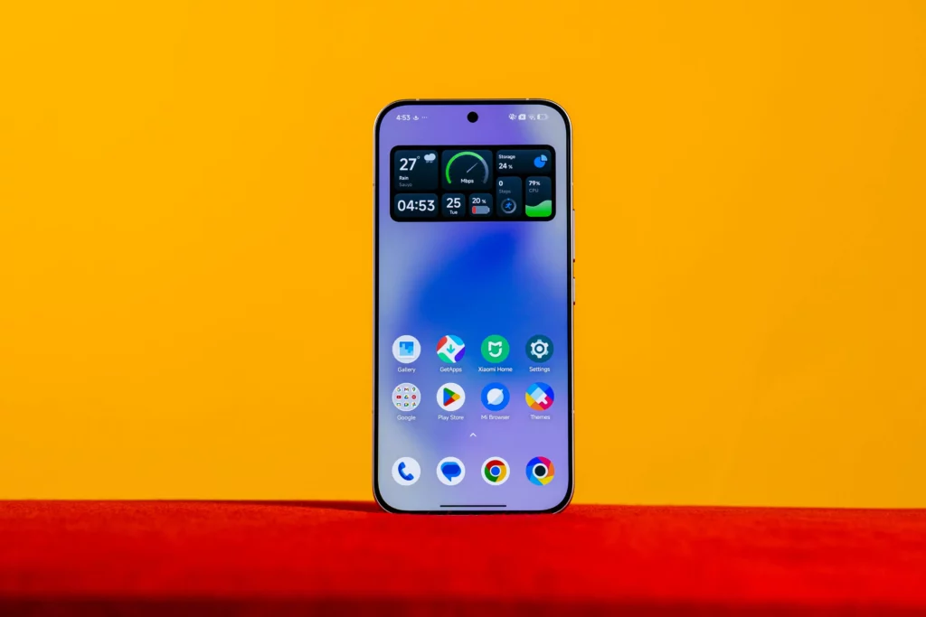 A full view of the POCO F8 Ultra smartphone screen, displaying the home screen with a dark-themed widget showing weather, storage, and battery, set against a vibrant orange and yellow background.