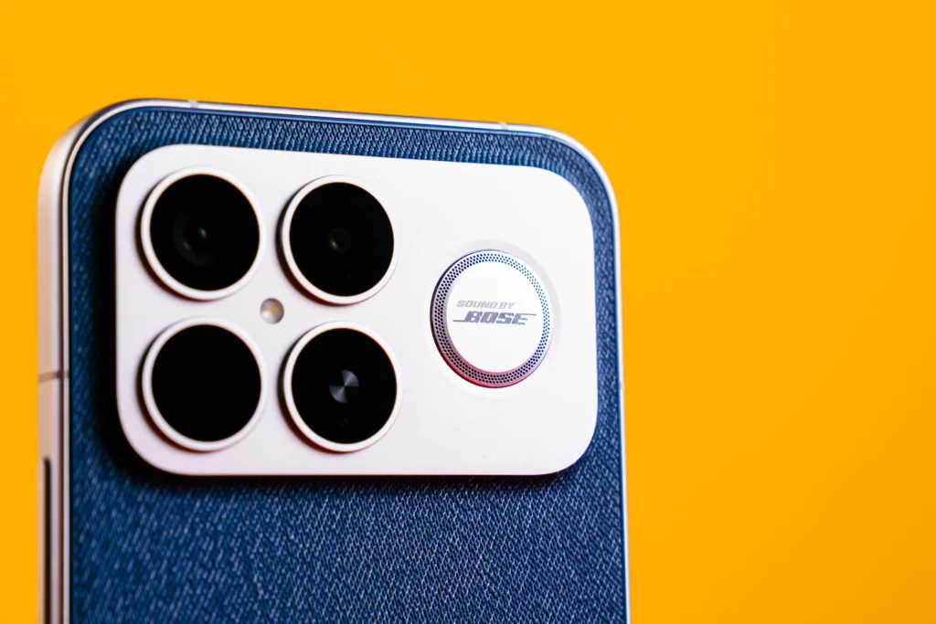 A close-up, angled view of the back of the POCO F8 Ultra, highlighting the camera module with four large lenses and a circular "Sound by BOSE" logo. The phone has a blue, textured backing (possibly denim-like).