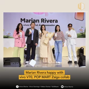 Five people, including brand ambassador Marian Rivera and host Dani Mortel, stand on a stage holding the new vivo V70 smartphone. A large screen behind them displays "Marian Rivera, vivo Brand Ambassador".