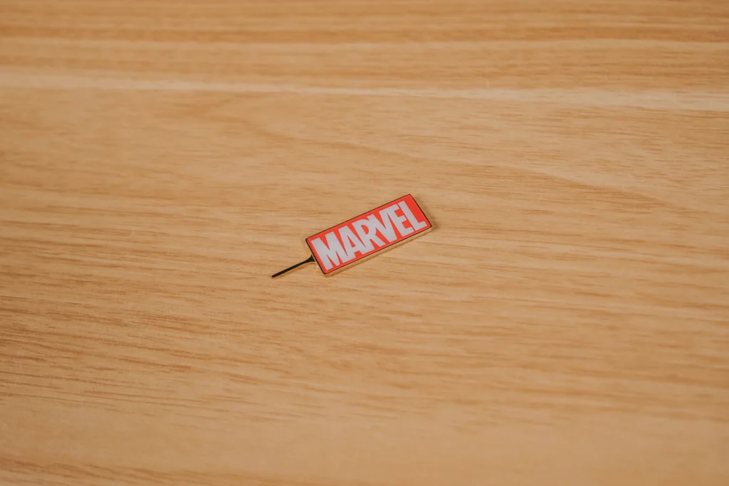 The back of the POCO X8 Pro Iron Man Edition smartphone. It has a matte black finish with a glossy centerpiece depicting Iron Man in flight, accented by gold streaks and a "STARK INDUSTRIES" logo at the bottom.