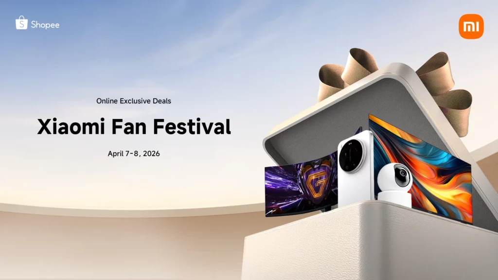 A clean promotional banner for the "Xiaomi Fan Festival" taking place on April 7–8, 2026. It features a minimalist aesthetic with a soft blue sky background. An elegant, textured white gift box is open, revealing various Xiaomi ecosystem products like a high-end smartphone with a large camera module, a security camera, and a television. The Shopee and Xiaomi logos are visible at the top corners.