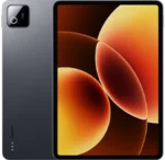 Back and front view of a Xiaomi Pad 8 tablet in matte space gray. The rear has a small, square camera module in the top corner. The front shows slim, uniform bezels surrounding a large display featuring an abstract wallpaper with warm orange and amber glowing orbs.