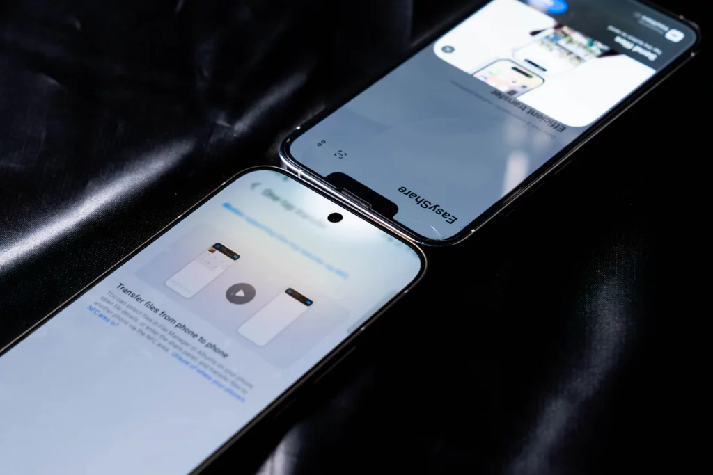 Two smartphones placed top-to-top to demonstrate the "EasyShare" one-tap file transfer feature. The vivo V70 5G is in the foreground with the transfer interface visible.